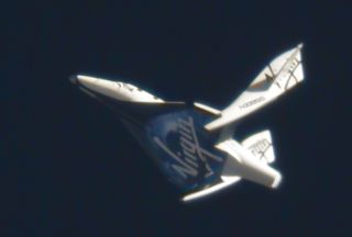 Virgin Galactic's suborbital passenger ship SpaceShipTwo flexes its feathered re-entry system during a pivotal glide test at the Mojave Air and Space Port in California on May 4, 2011.