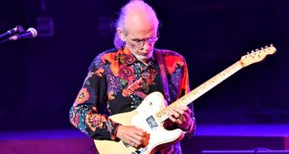 Steve Howe wears a brightly patterned shirt and plays his modded 1955 Telecaster