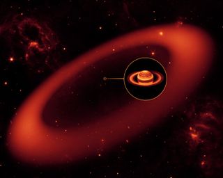 An artist's depiction of the massive faint ring around Saturn that Spitzer identified.