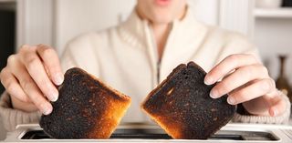 Burned toast coming from the toaster