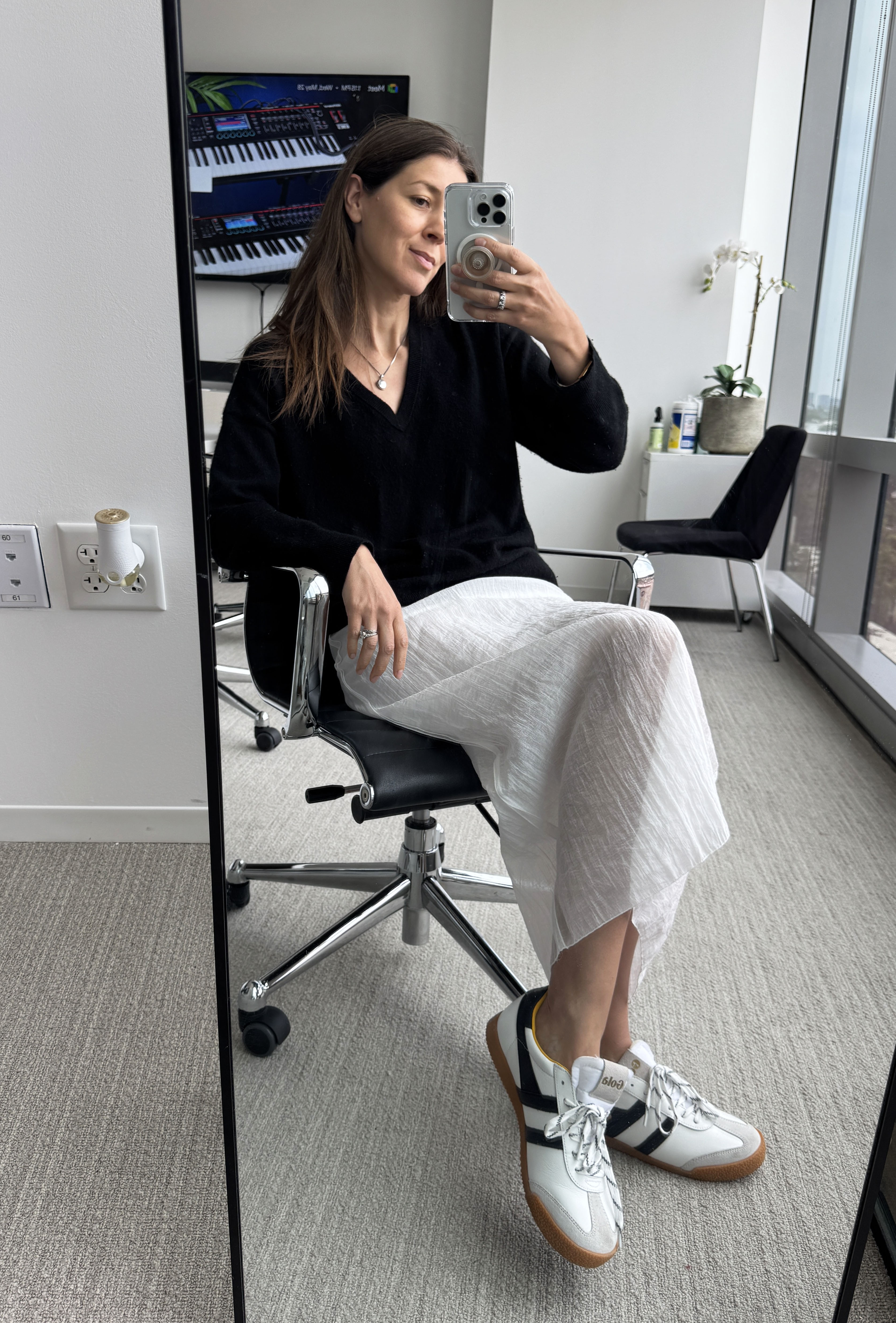 Woman in sheer white skirt and black sweater