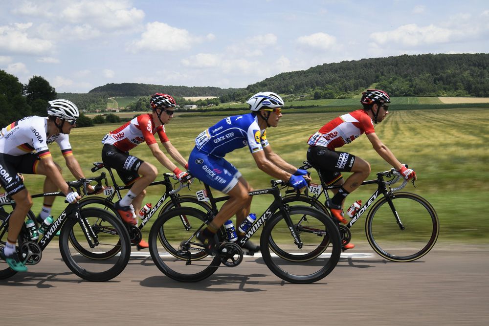 A side shot of the peloton captures Philippe Gilbert and Thomas de Gendt leading the peloton