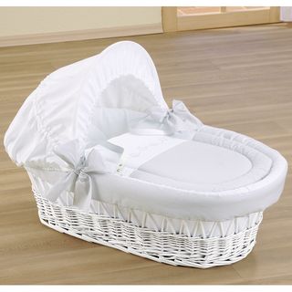 wooden flooring with moses basket and white color