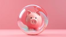 A piggy bank is enclosed in a protective bubble against a pink background.