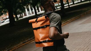 Runner wearing the IAMRUNBOX Everyday Rolltop backpack