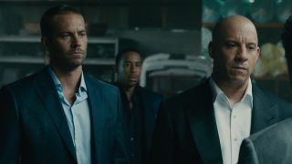 From left to right: Paul Walker, Ludacris in the background, and Vin Diesel in Furious 7