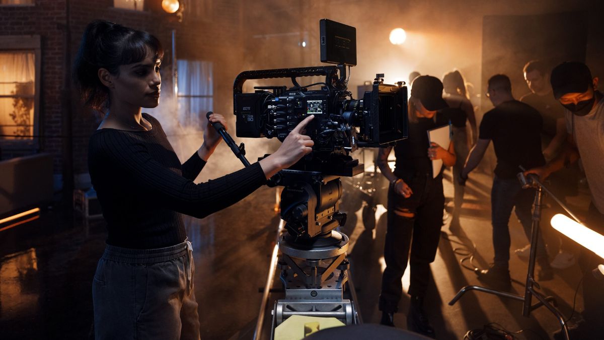 Woman using Red V-Raptor camera on film set