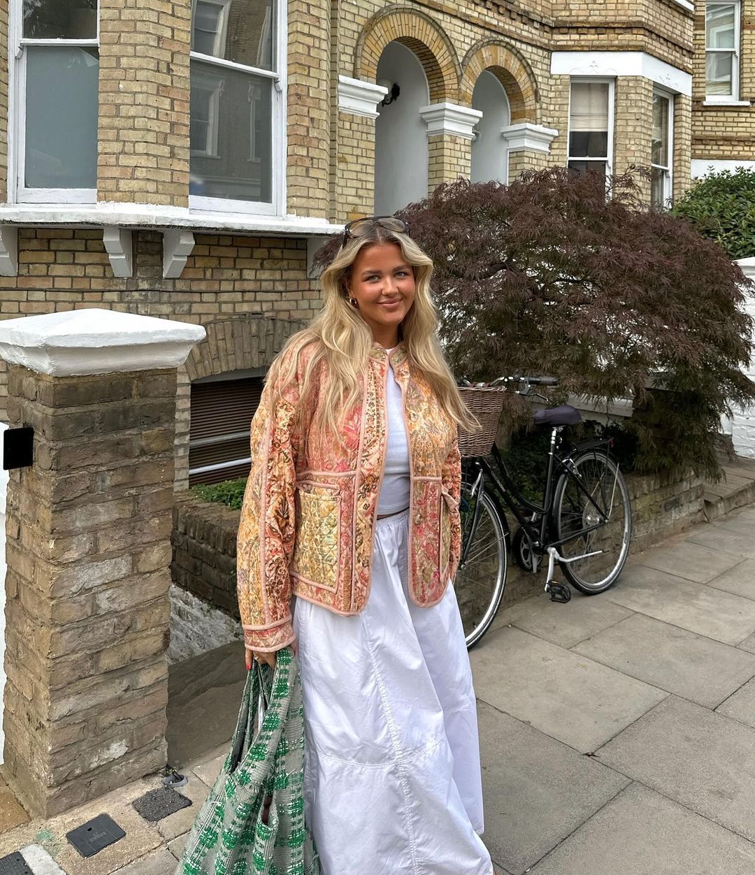 Grace wears a floral-print quilted jacket with a cargo maxi skirt.