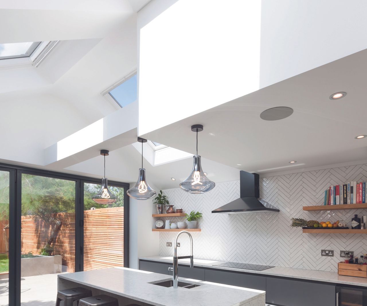 a contemporary pitched roof kitchen extension with skylights causing a feeling of brightess and openess