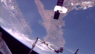 SpaceX's Dragon cargo ship flies over Italy (the country's boot shape can be seen upside in the background) while delivering vital NASA supplies to the International Space Station on Aug. 16, 2017.
