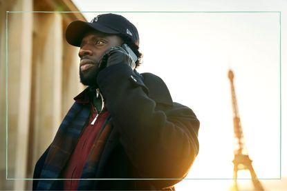 Omar Sy as Assane Diop in Lupin with the Eiffel Tower in the background