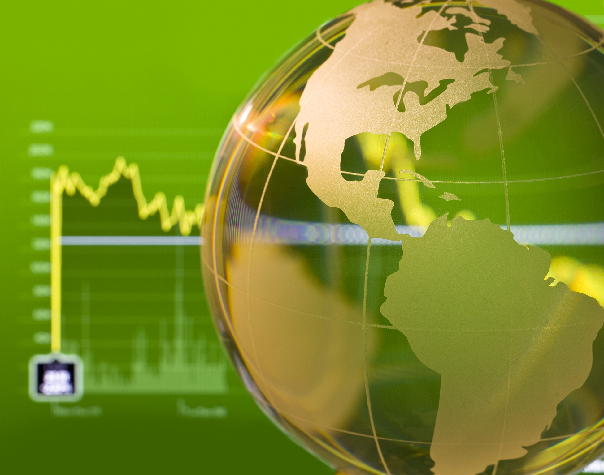 Glass globe over stock data on computer screen, global stocks concept