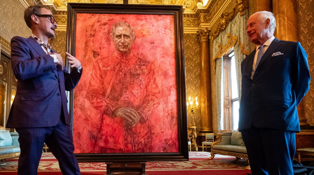 Artist Jonathan Yeo and King Charles III stand in front of the portrait of the King Charles III by artist Jonathan Yeo as it is unveiled in the blue drawing room at Buckingham Palace on May 14, 2024 in London, England. 