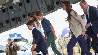 The Wales family stepping onto an aircraft