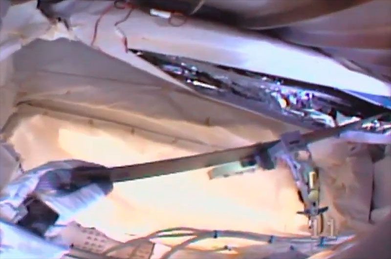 Astronaut Luca Parmitano works to break off a carbon composite insulation cover on the Alpha Magnetic Spectrometer (AMS) during a spacewalk on Friday, Nov. 15, 2019.