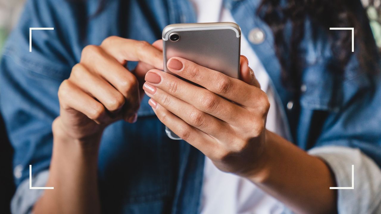 A woman&#039;s manicured hand holding iPhone and pressing buttons to represent the best sex apps