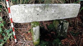 Here we see a stone engraved sign sitting on two smaller stone supports.