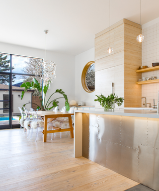 Open plan kitchen diner with glazed doors onto poolside