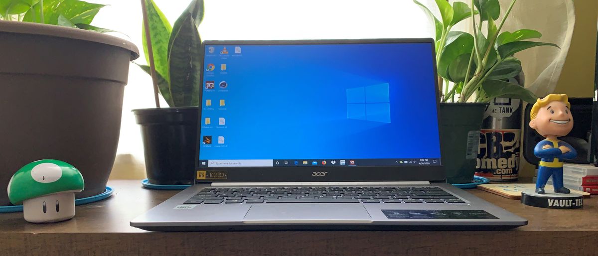 The Acer Swift 3 (2020) surrounded by plants on a table