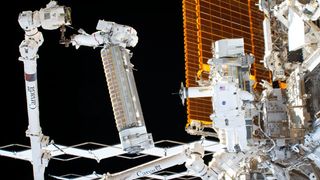 NASA astronauts (left to right) Josh Cassada and Frank Rubio pictured during a spacewalk installing a roll-out solar array, or iROSA, to the International Space Station's starboard truss structure.