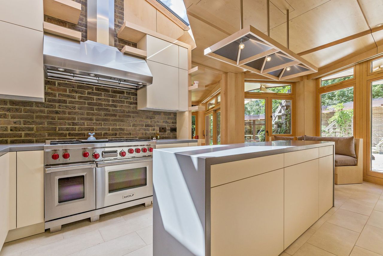 The kitchen in the home with a slick grey counter on a kitchen island