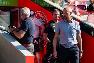 Manchester United manager Erik ten Hag watches from the dugout during the Premier League match between Brentford FC and Manchester United at Brentford Community Stadium on August 13, 2022 in Brentford, England.