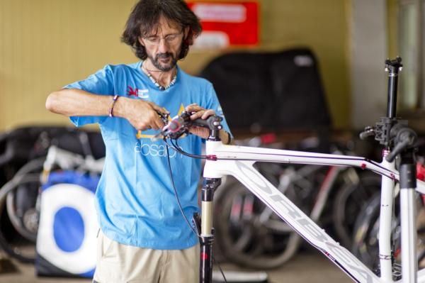 A rider works on his bike
