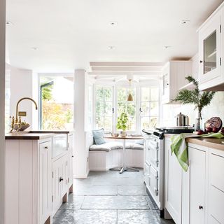 white kitchen with bay window and banquette seat