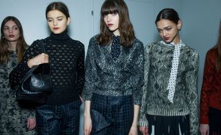 Models wearing classic-looking sweaters with see-through patterns in black and gray, from the Bottega Veneta A/W 2015.