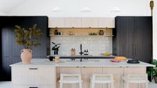 kitchen with black cupboards and white zellige tiles by Husk