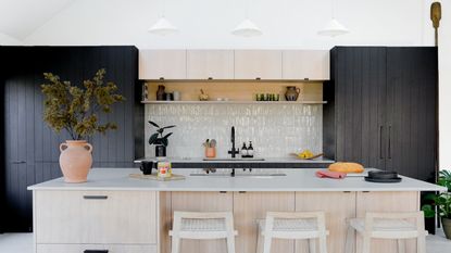 kitchen with black cupboards and white zellige tiles by Husk