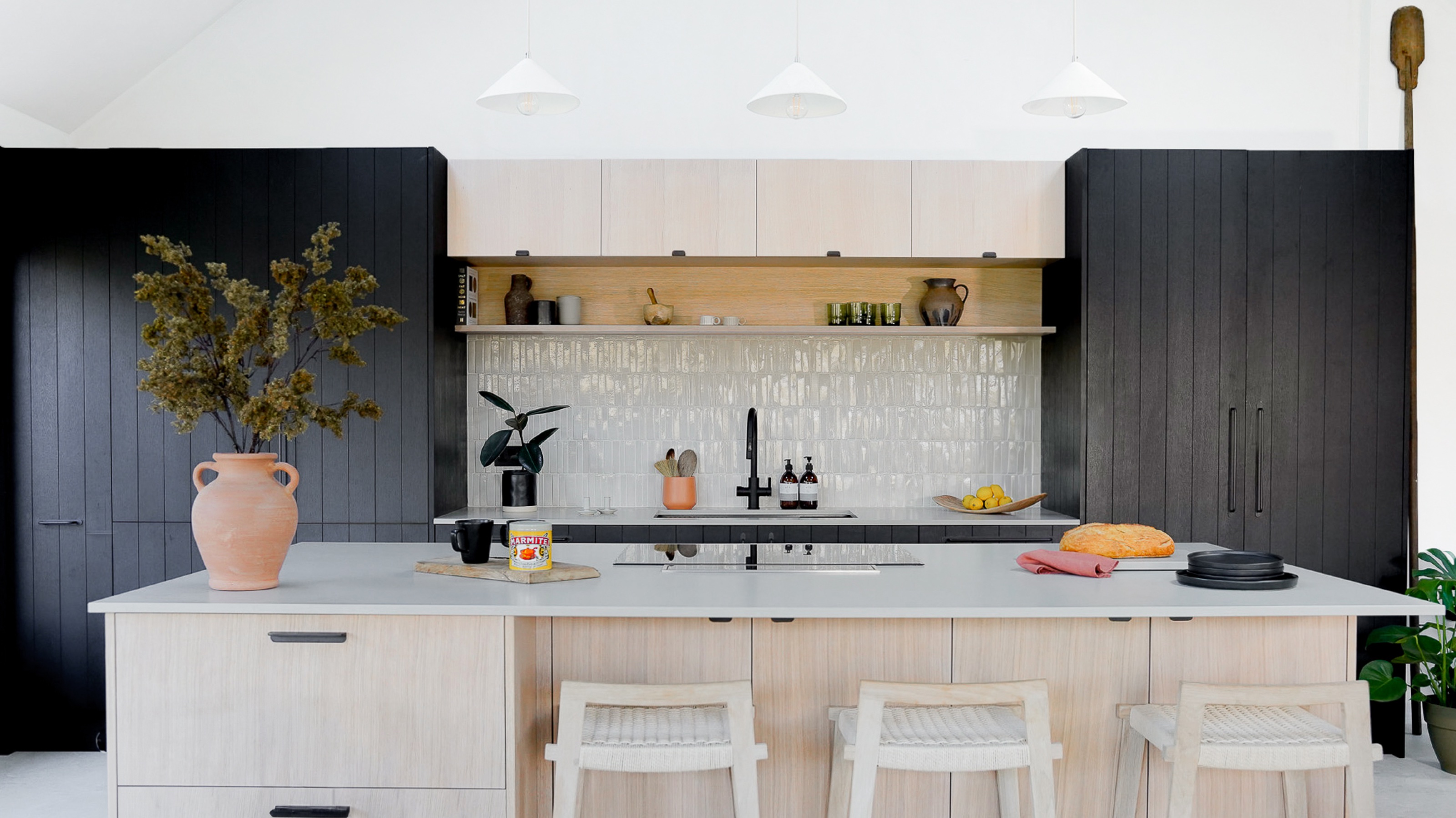 kitchen with black cupboards and white zellige tiles by Husk