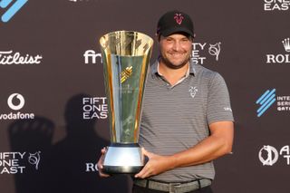 Peter Uihlein holds the International Series Qatar trophy