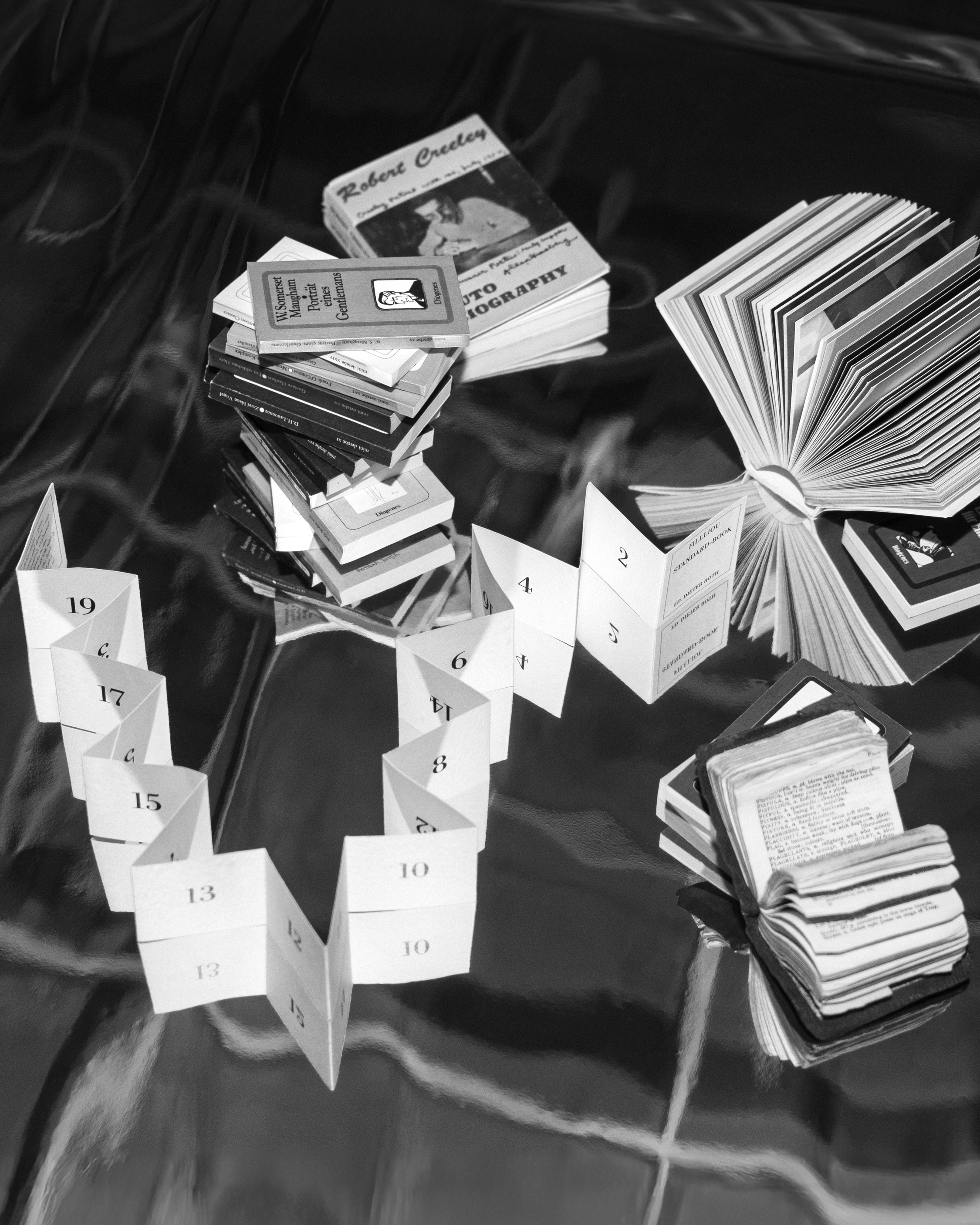 small books arranged across a glossy surface