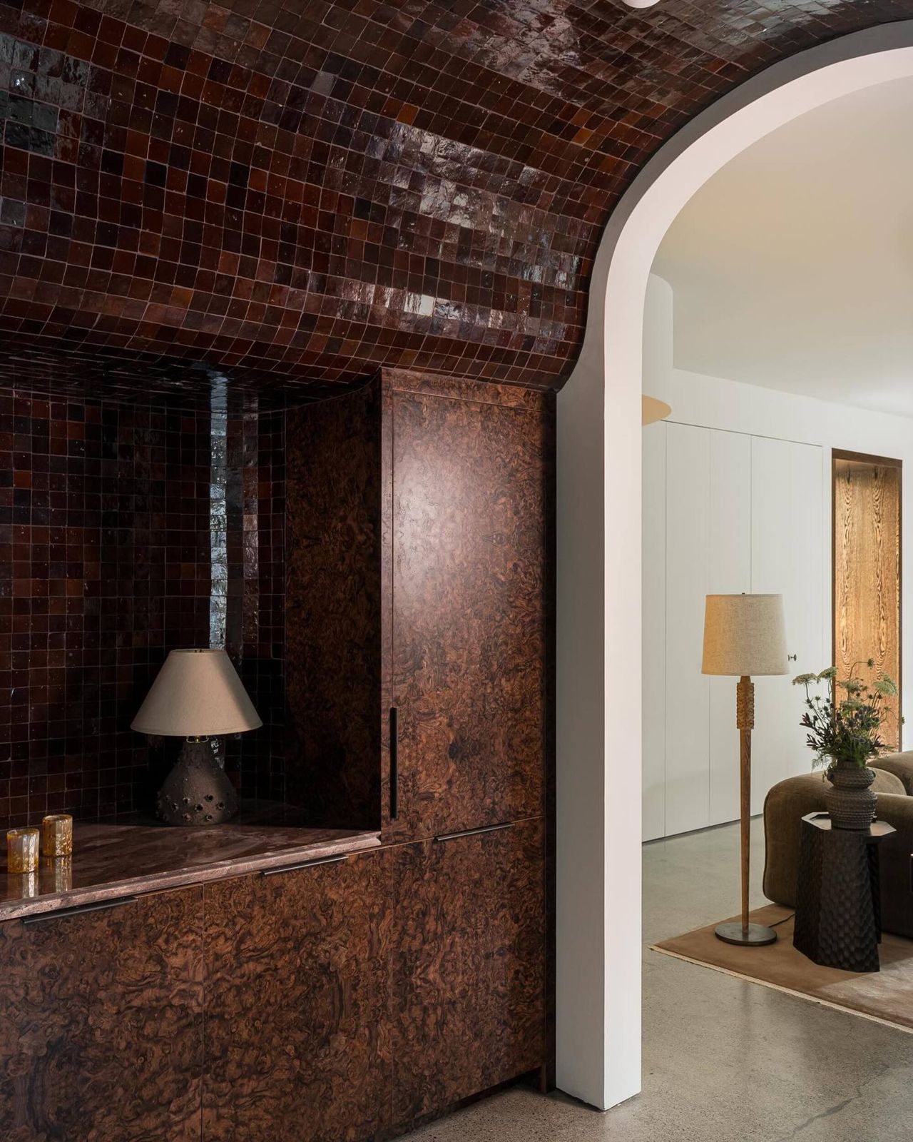 galley kitchen with dark brown tile climbing the wall and ceiling