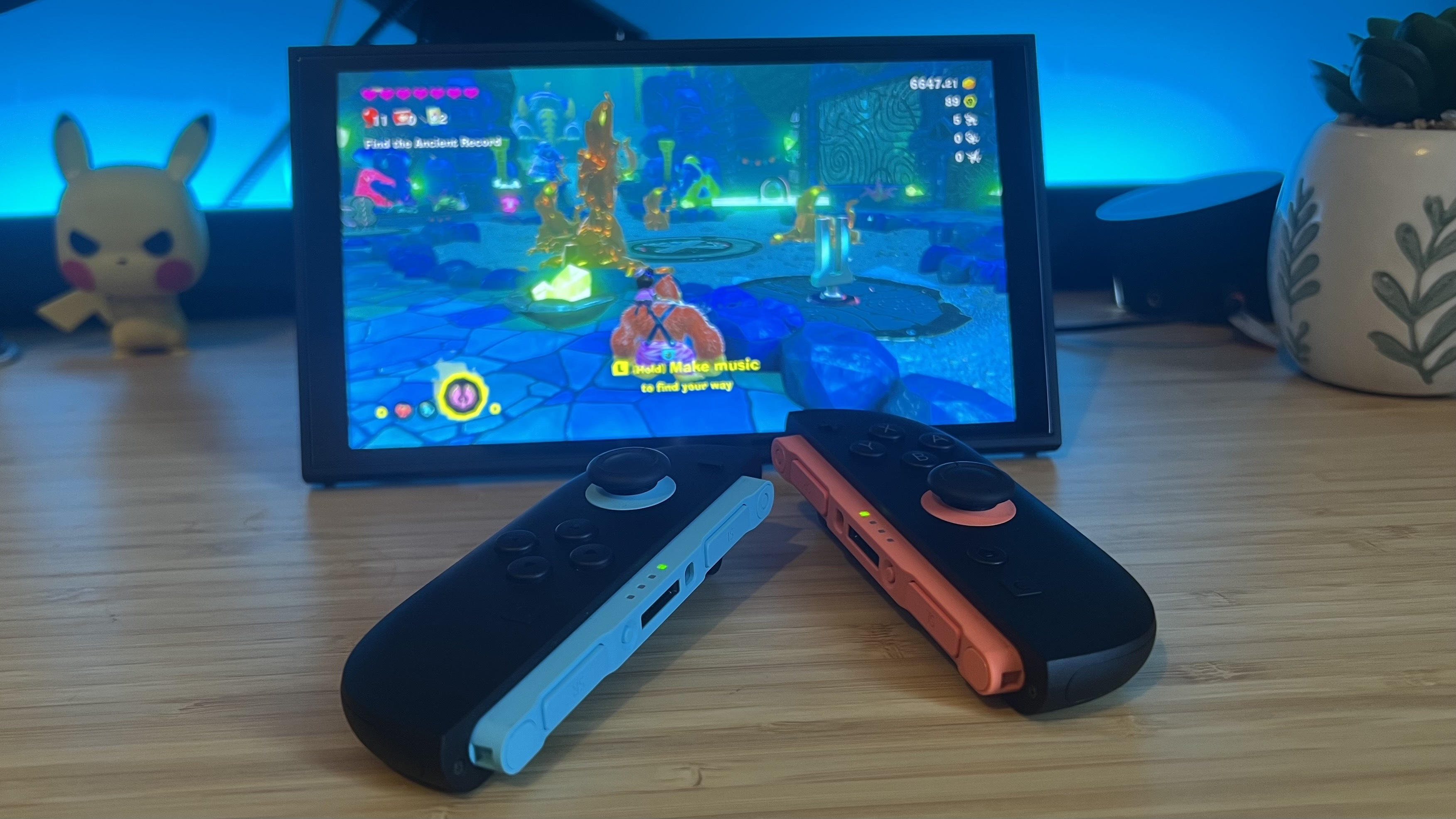 Nintendo Switch 2 Joy-Con in front of handheld running Donkey Kong Bananza