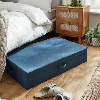 dunelm fabric storage box under a bed in a bedroom with wood flooring