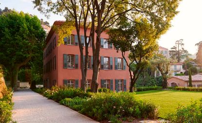 Pink house in Grasse France surrounded by trees