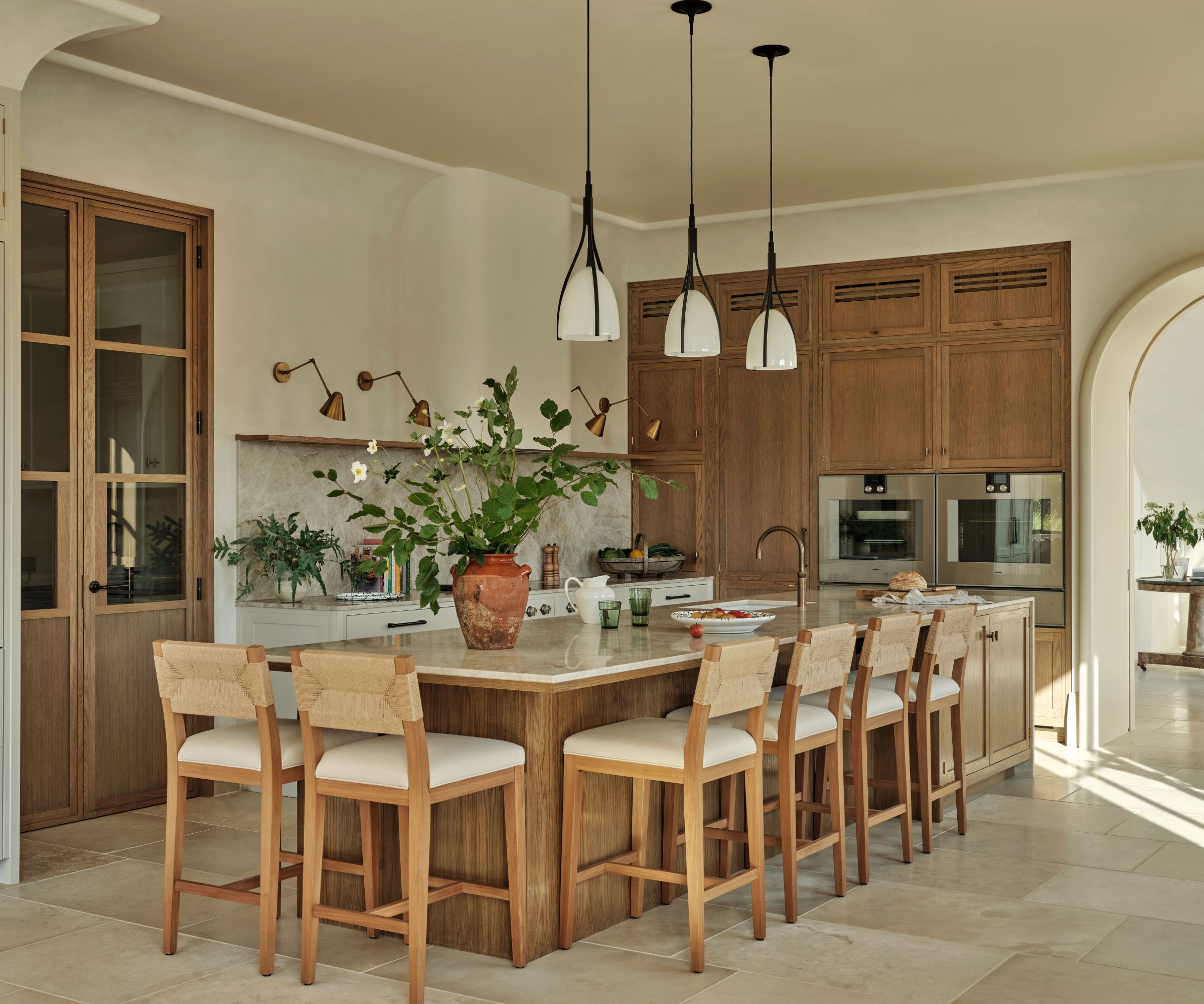 A warm, lived in kitchen with wooden cabinets