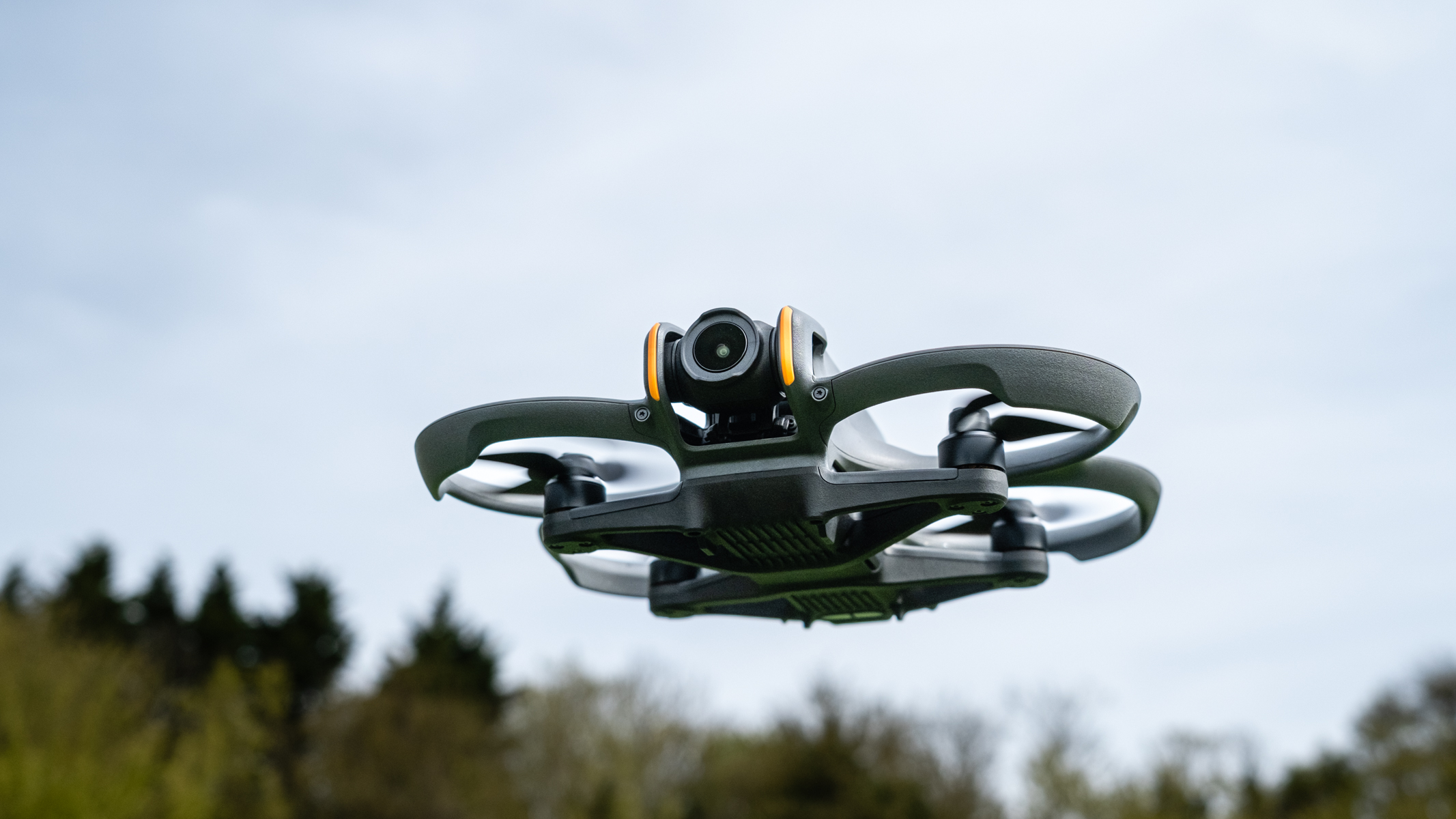 DJI Avata 2 in flight against a cloudy sky