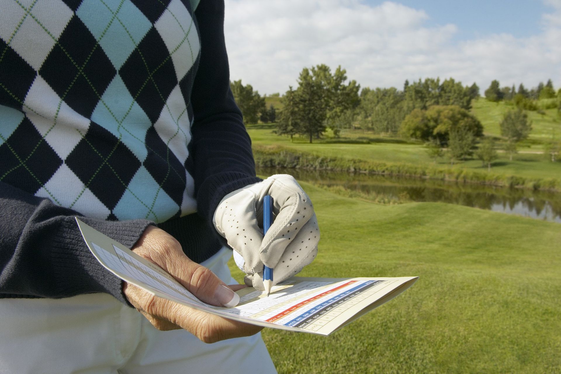 Golfer filling in scorecard GettyImages-522917188