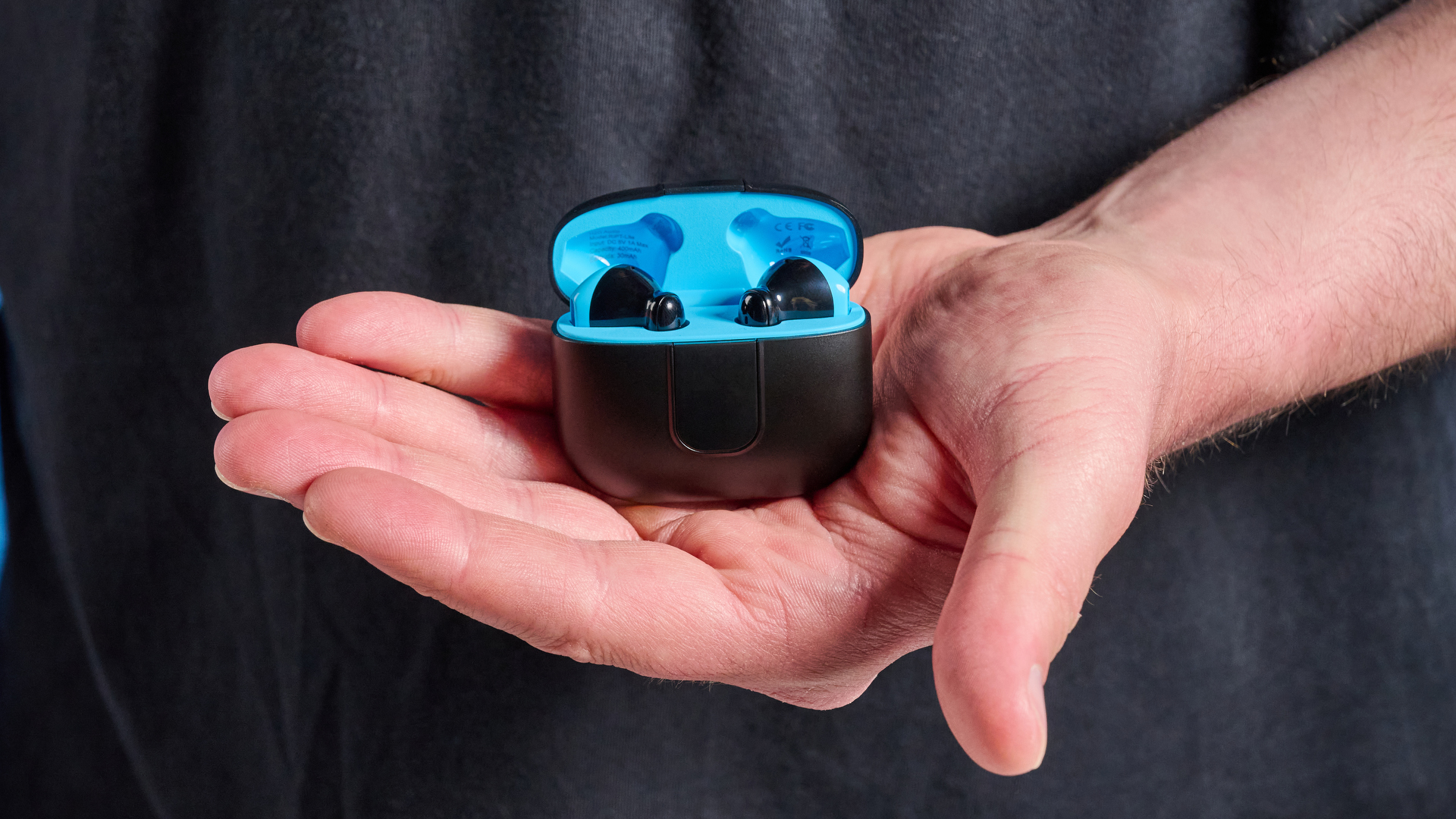 the h2o audio ript-lite earbuds in black and blue, photographed against a blue background, for both working out and everyday use
