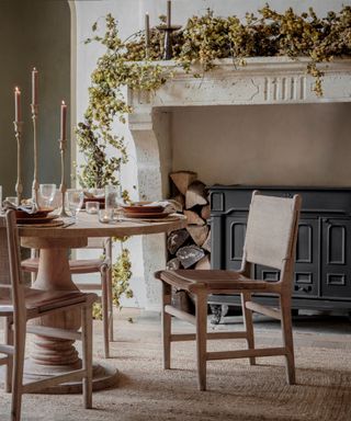 Dining table by a fall fireplace decorated with a hops garland