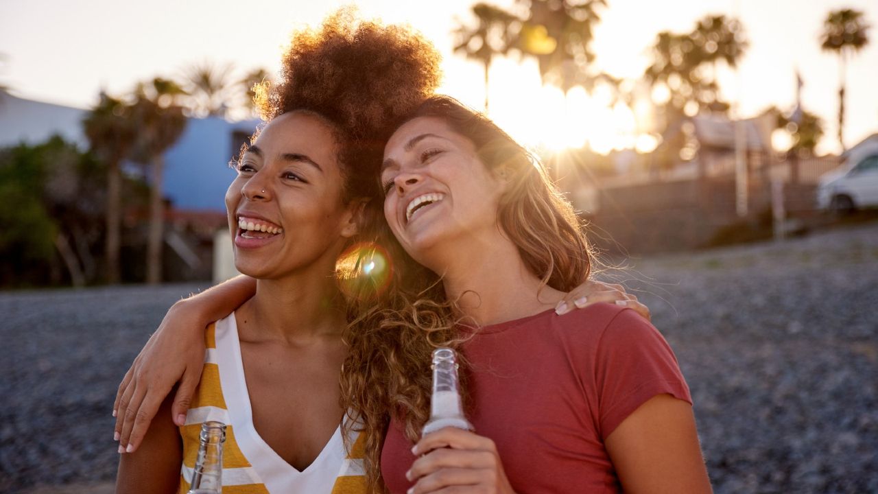 Two best friends having fun on the beach - stock photo