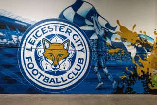 The Leicester City badge painted on a wall in the stands at the King Power Stadium