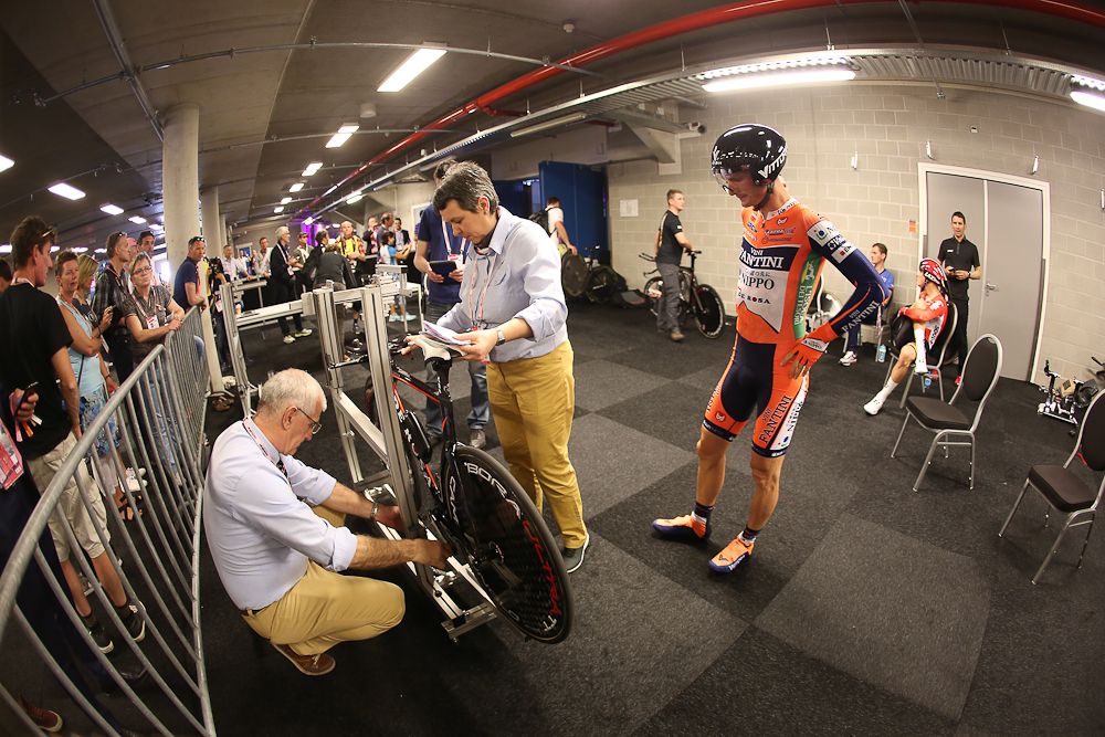 Commissares check the bike specs on the Giro's opening day.