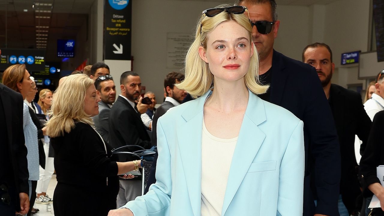 Elle Fanning wearing a blue Bottega Veneta suit at the airport in Nice, France May 2024