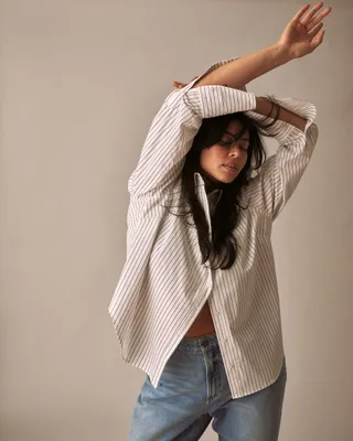Model Lauren Chan wears Henning X US Madison Shirt in White/grey Stripe