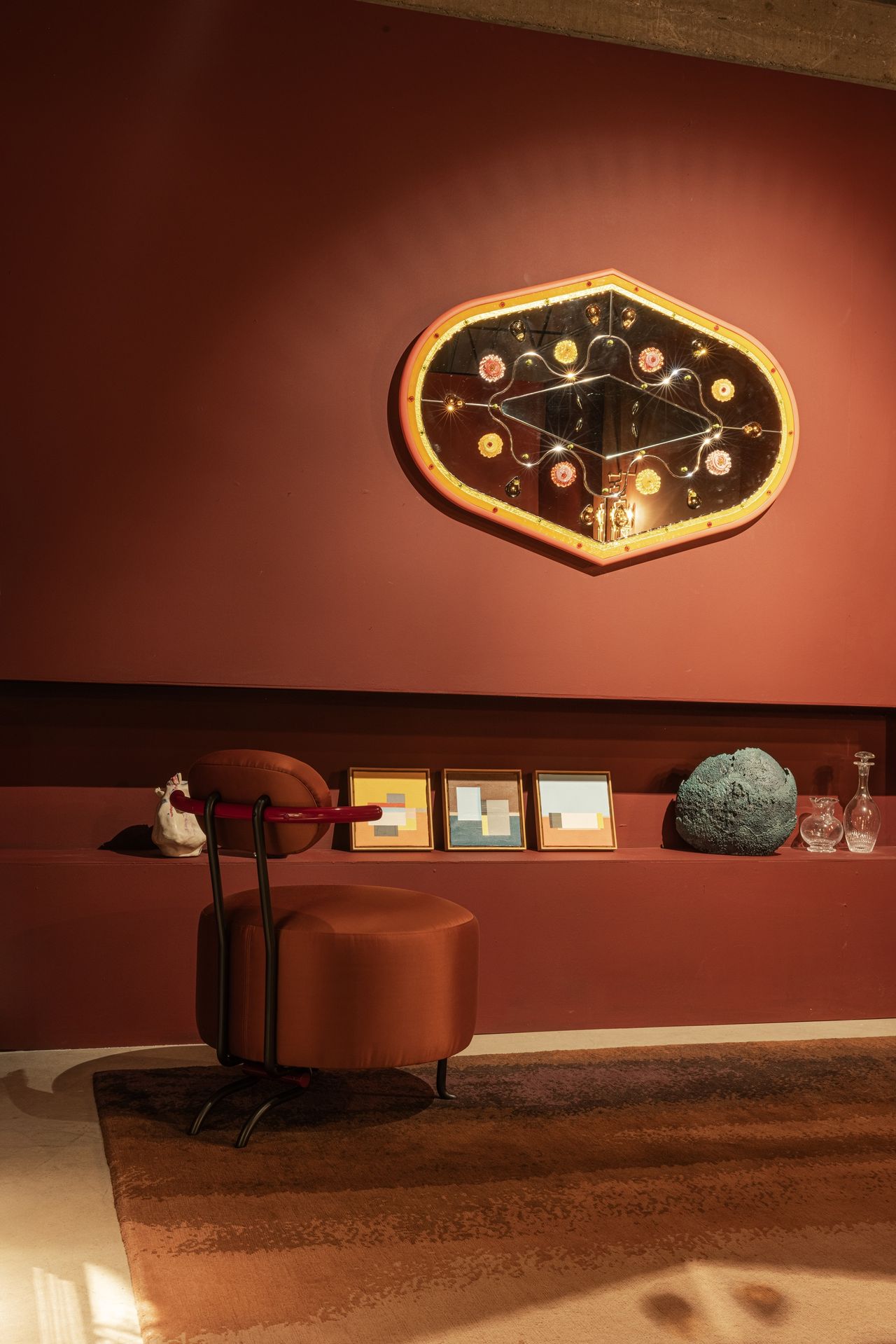an orange room with an orange chair and decor on the walls