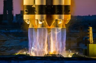 A dazzling view of the first stage engines of a Russian Proton rocket firing to launch the Electro-L 3 weather satellite into orbit from Baikonur Cosmodrome, Kazakhstan on Dec. 24, 2019.